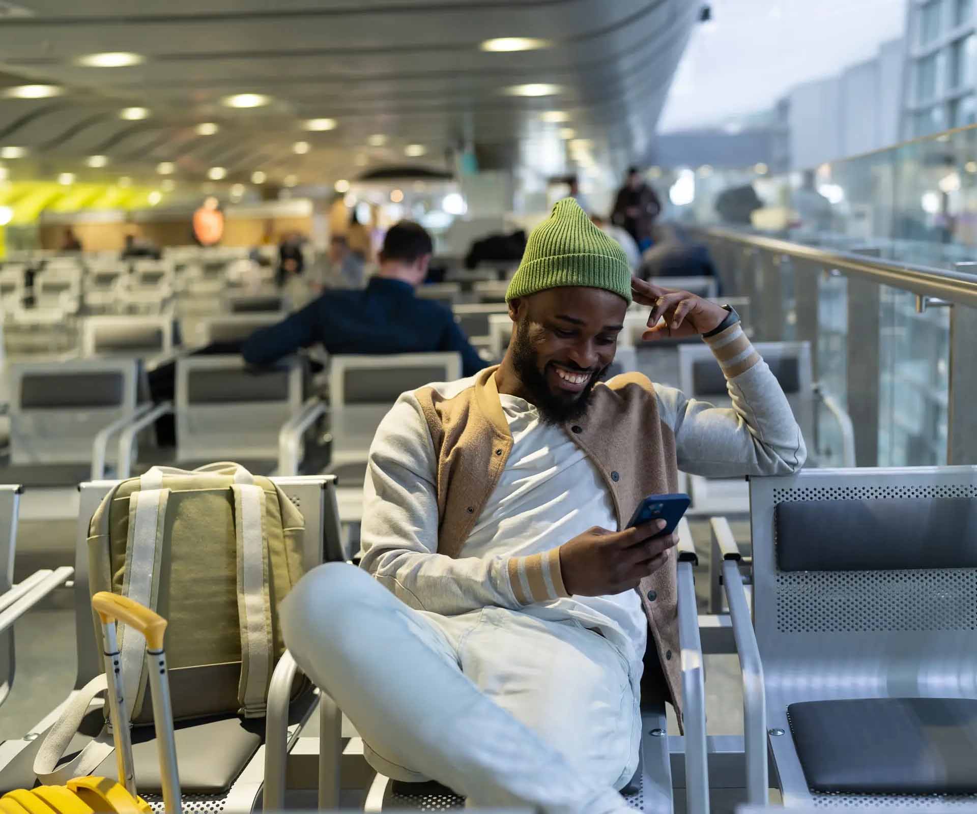 traveller looking at phone in airport